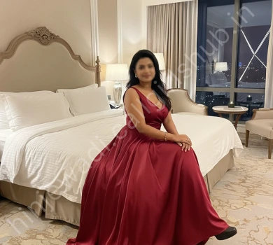 VIP call girl in hinjewadi wearing red gown sitting on bed